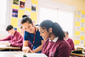 Teacher helping a pupil during a lesson taught in English at The Benalmádena International College
