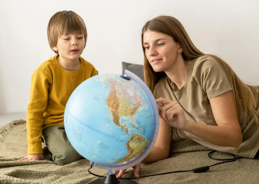Mother and son looking at a globe while weighing up a bilingual school or a British school